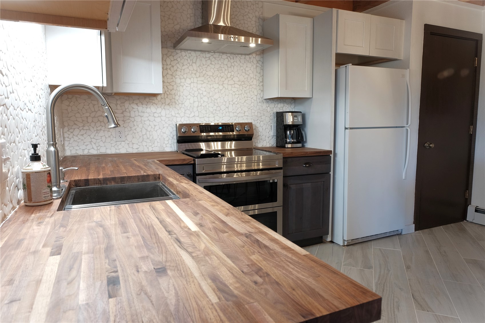 8500 Ryan Gulch Road, Unit 301 Silverthorne, CO 80498 - Photo 2 of 49 a kitchen with granite countertop a refrigerator stove and sink