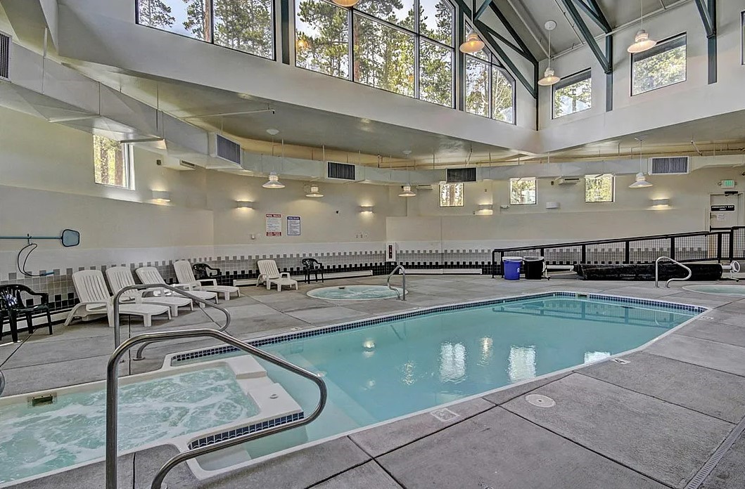 8500 Ryan Gulch Road, Unit 301 Silverthorne, CO 80498 - Photo 28 of 49 a view of a kitchen with kitchen island a sink and a view of living room