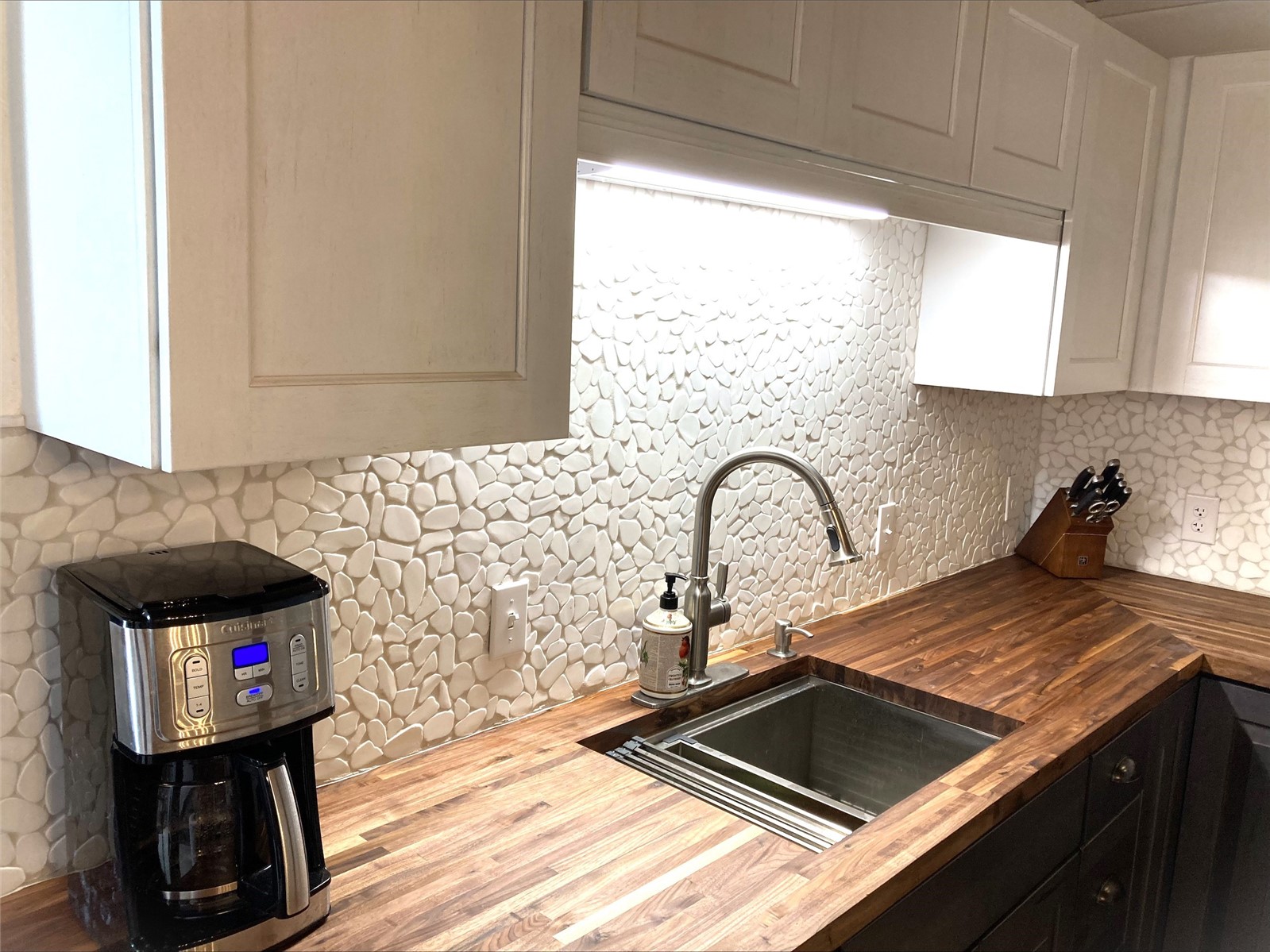 8500 Ryan Gulch Road, Unit 301 Silverthorne, CO 80498 - Photo 3 of 49 a kitchen with a sink and a stove top oven