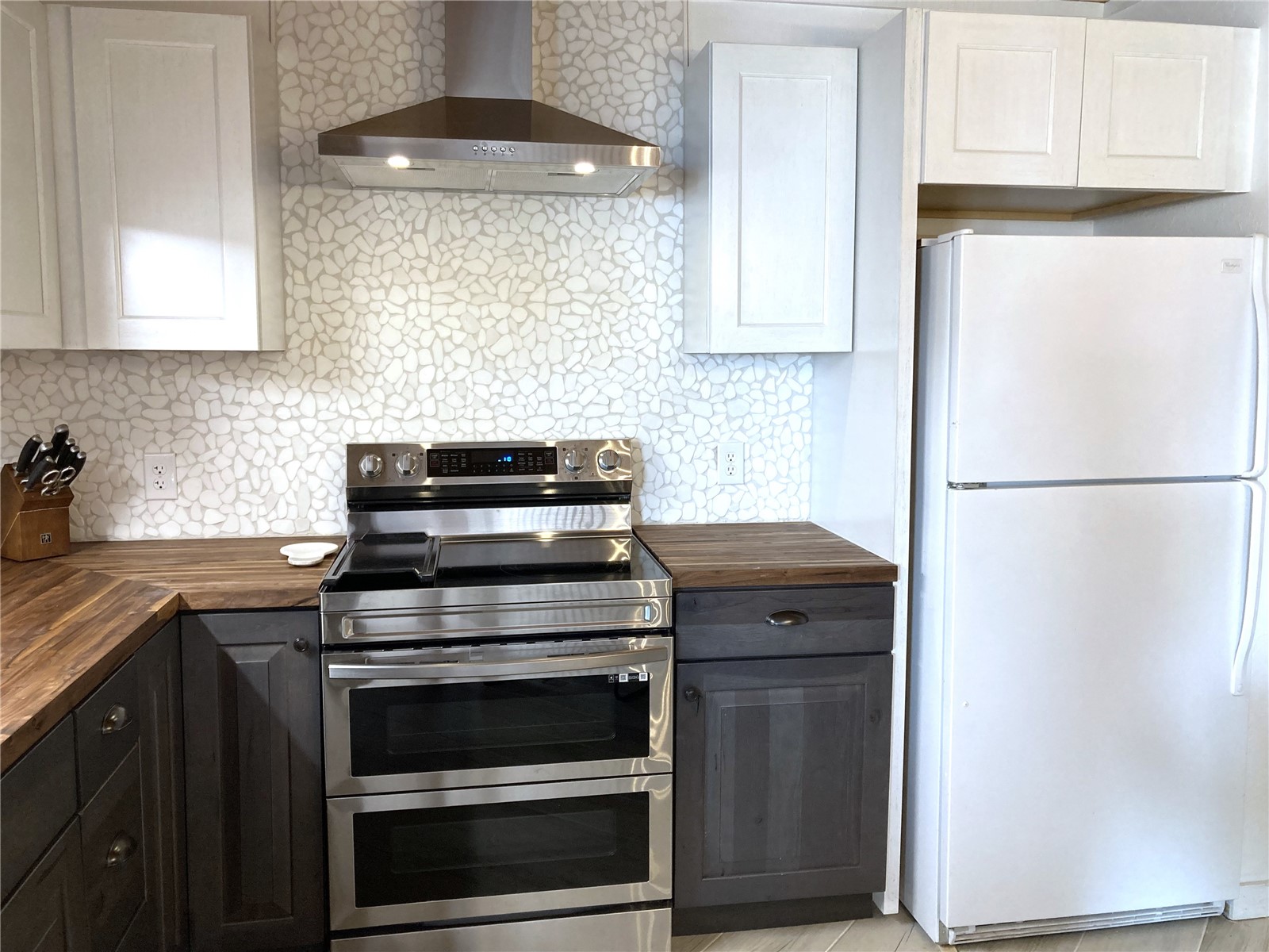 8500 Ryan Gulch Road, Unit 301 Silverthorne, CO 80498 - Photo 4 of 49 a kitchen with stainless steel appliances granite countertop a stove and a refrigerator