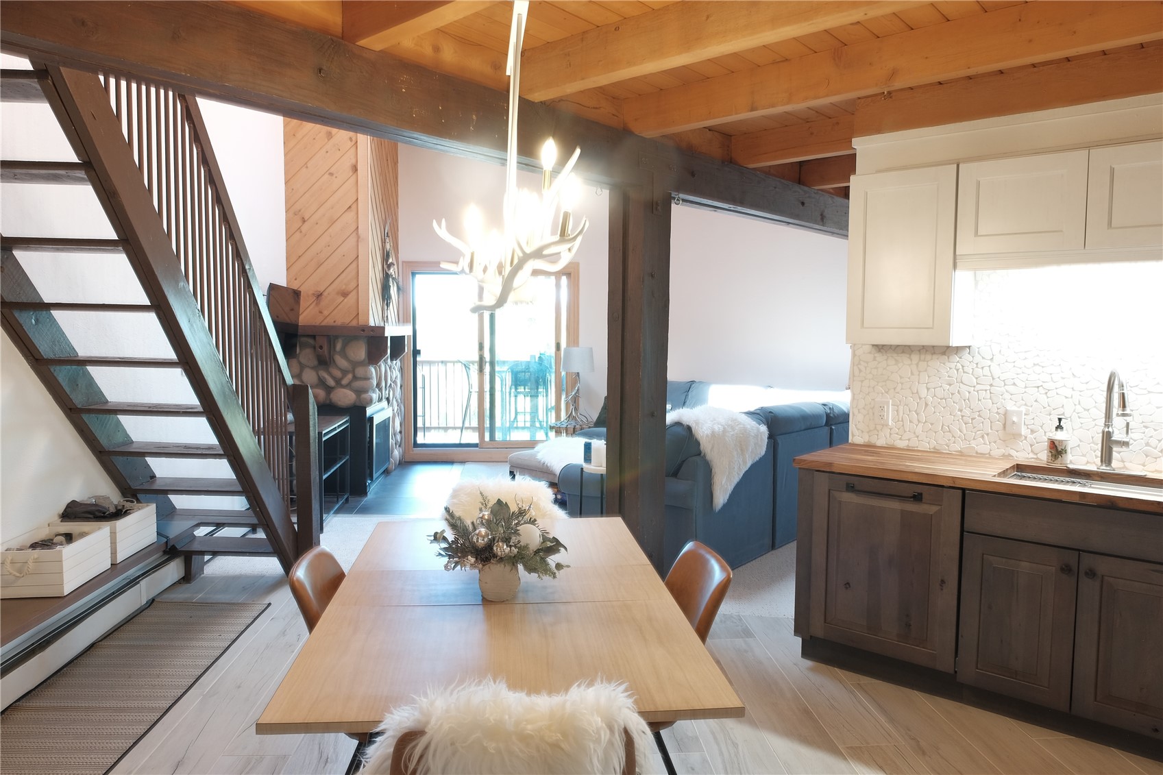8500 Ryan Gulch Road, Unit 301 Silverthorne, CO 80498 - Photo 5 of 49 a view of a dining room with furniture window and wooden floor