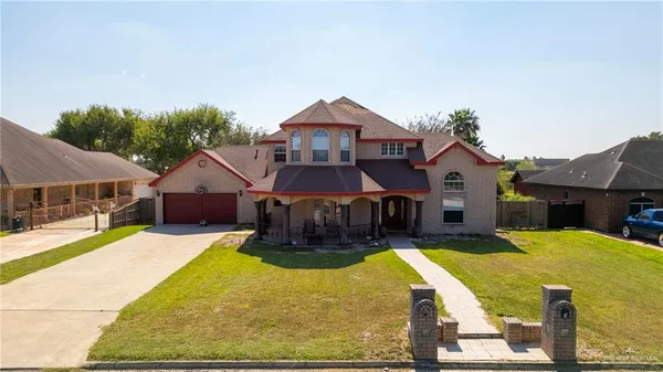 a front view of a house with yard and glass windows