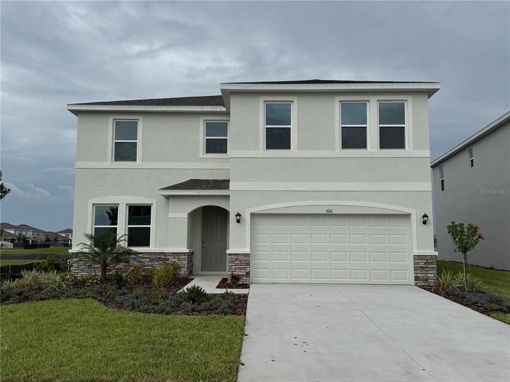 5116 Rosado Run Lakewood Ranch, FL 34211 - Photo 1 of 1 a front view of a house with a yard and garage