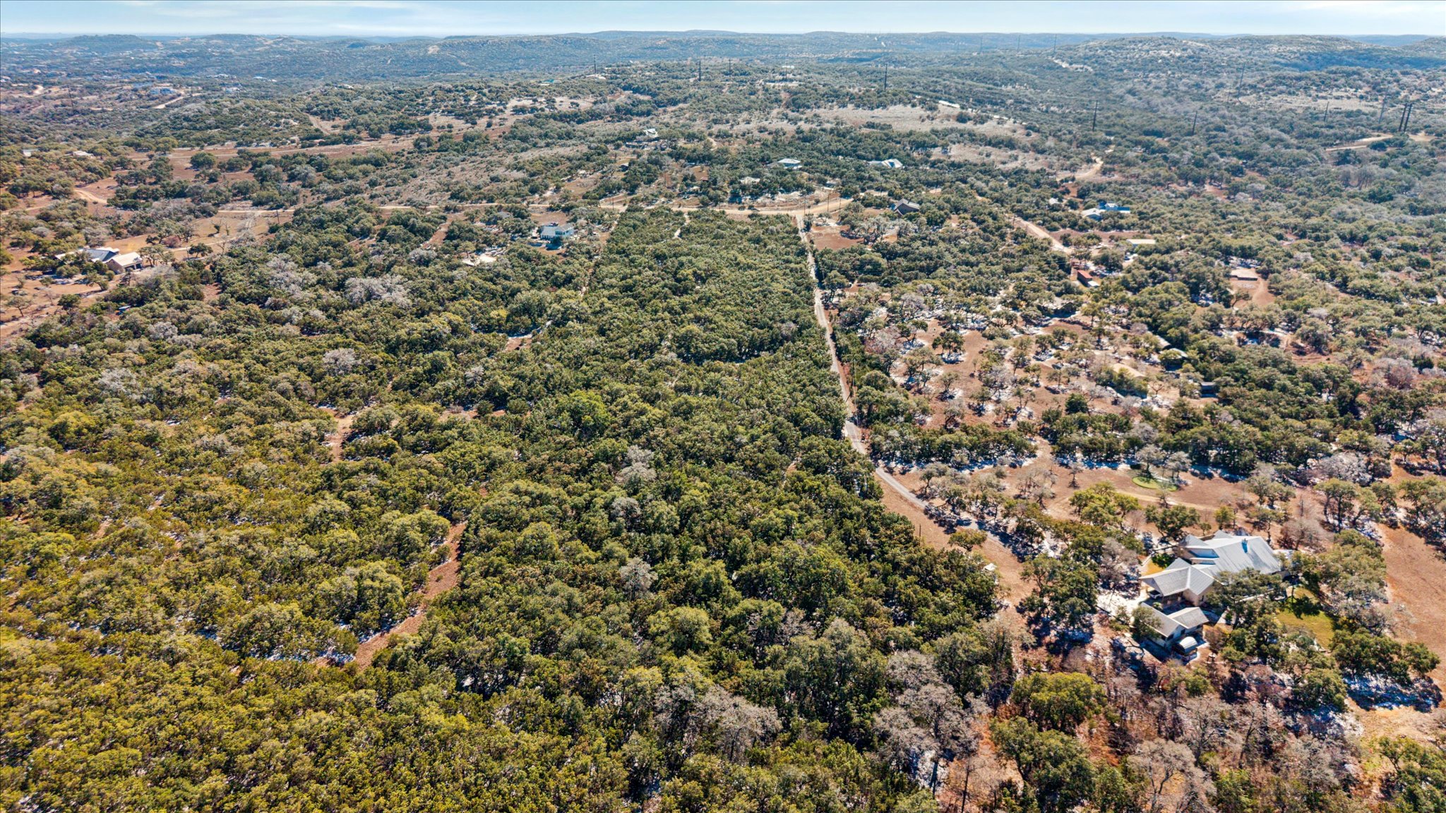 an aerial view of house with yard and mountain view in back