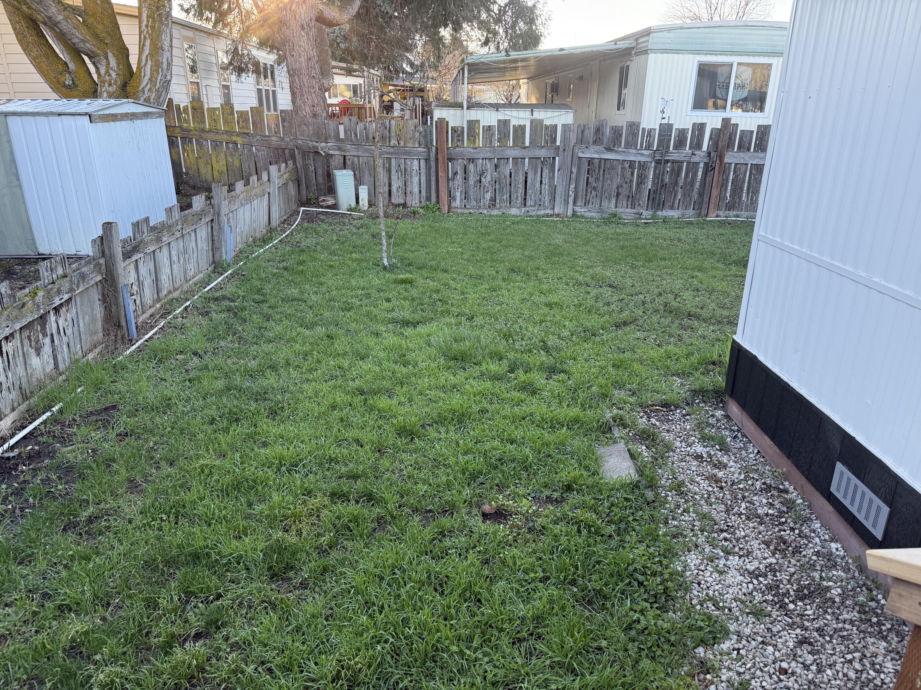 355 Colver Road, Unit 48 Talent, OR 97540 - Photo 13 of 30 a view of a yard with a wooden fence