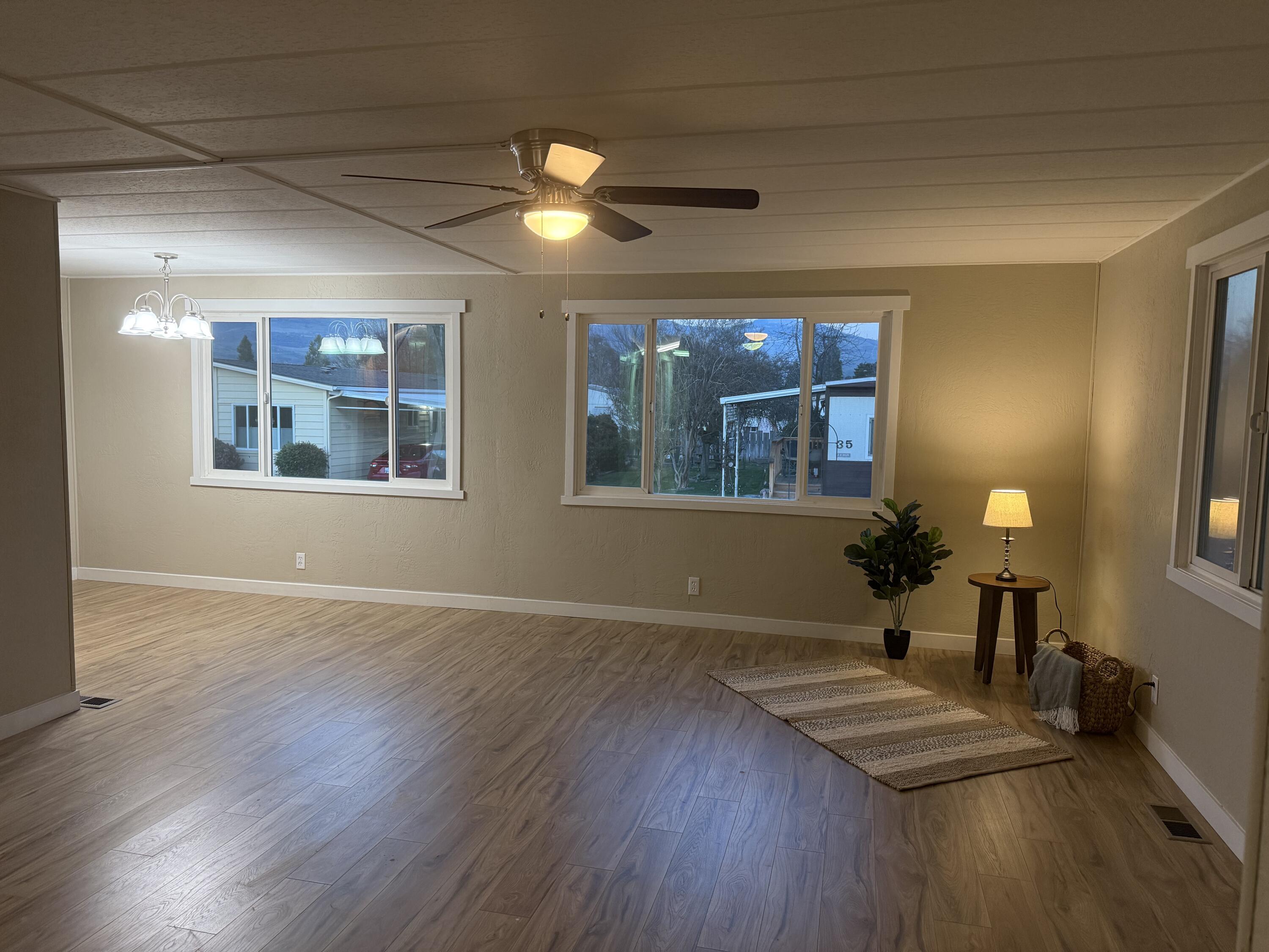 355 Colver Road, Unit 48 Talent, OR 97540 - Photo 14 of 30 a view of an empty room with wooden floor and a window