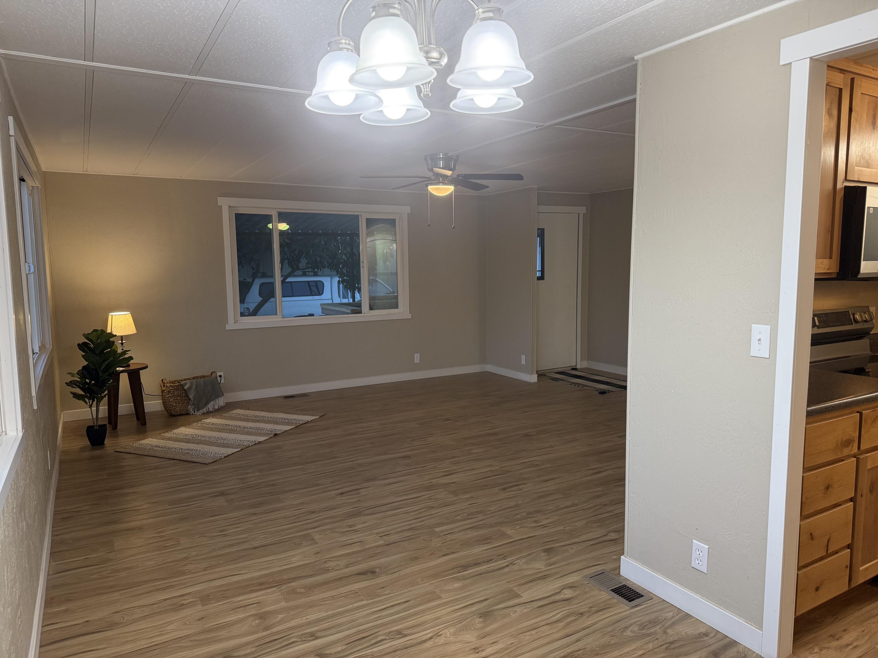 355 Colver Road, Unit 48 Talent, OR 97540 - Photo 15 of 30 a view of an empty room with wooden floor and a window