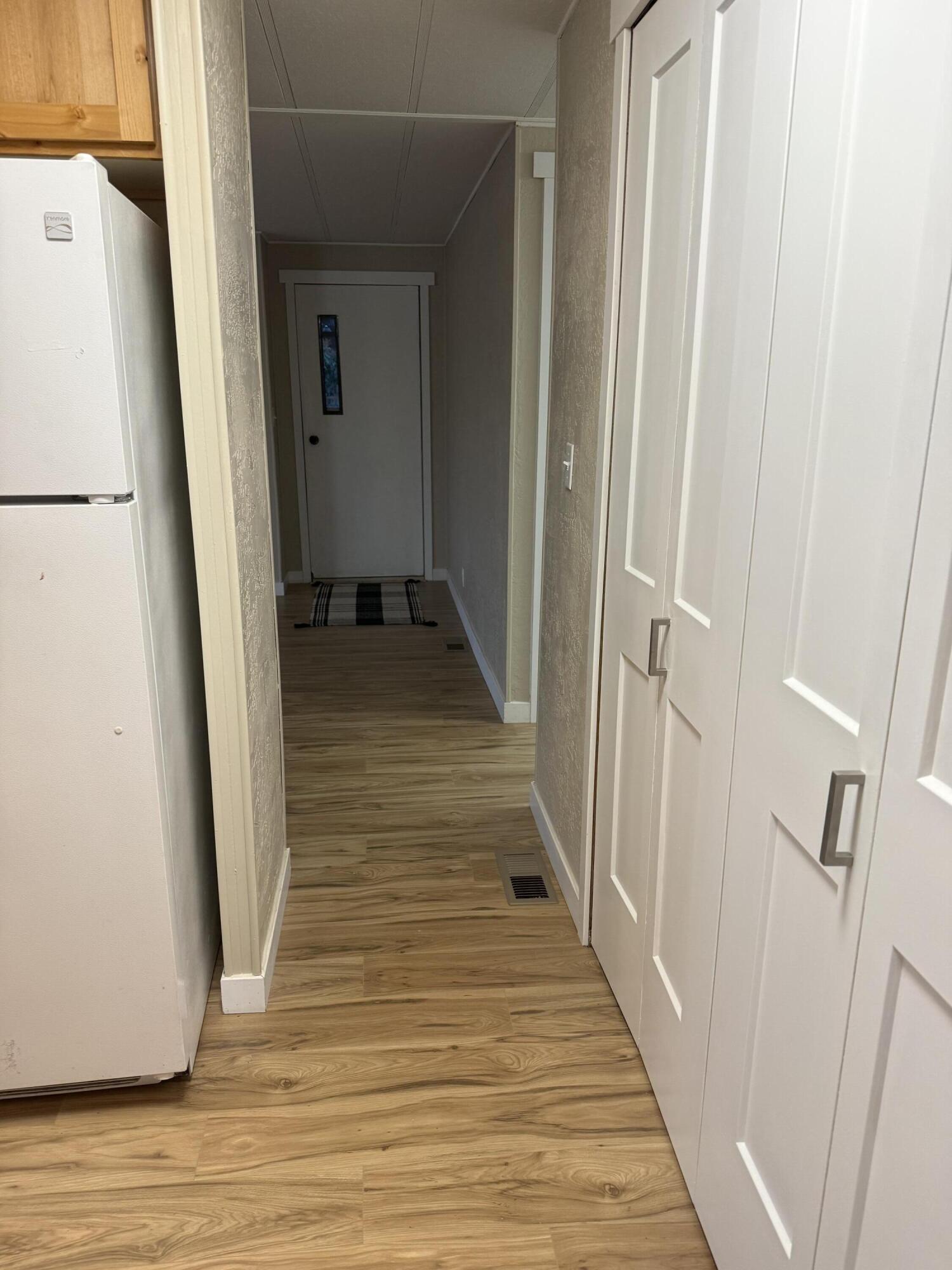 355 Colver Road, Unit 48 Talent, OR 97540 - Photo 19 of 30 a view of a hallway with wooden floor and staircase