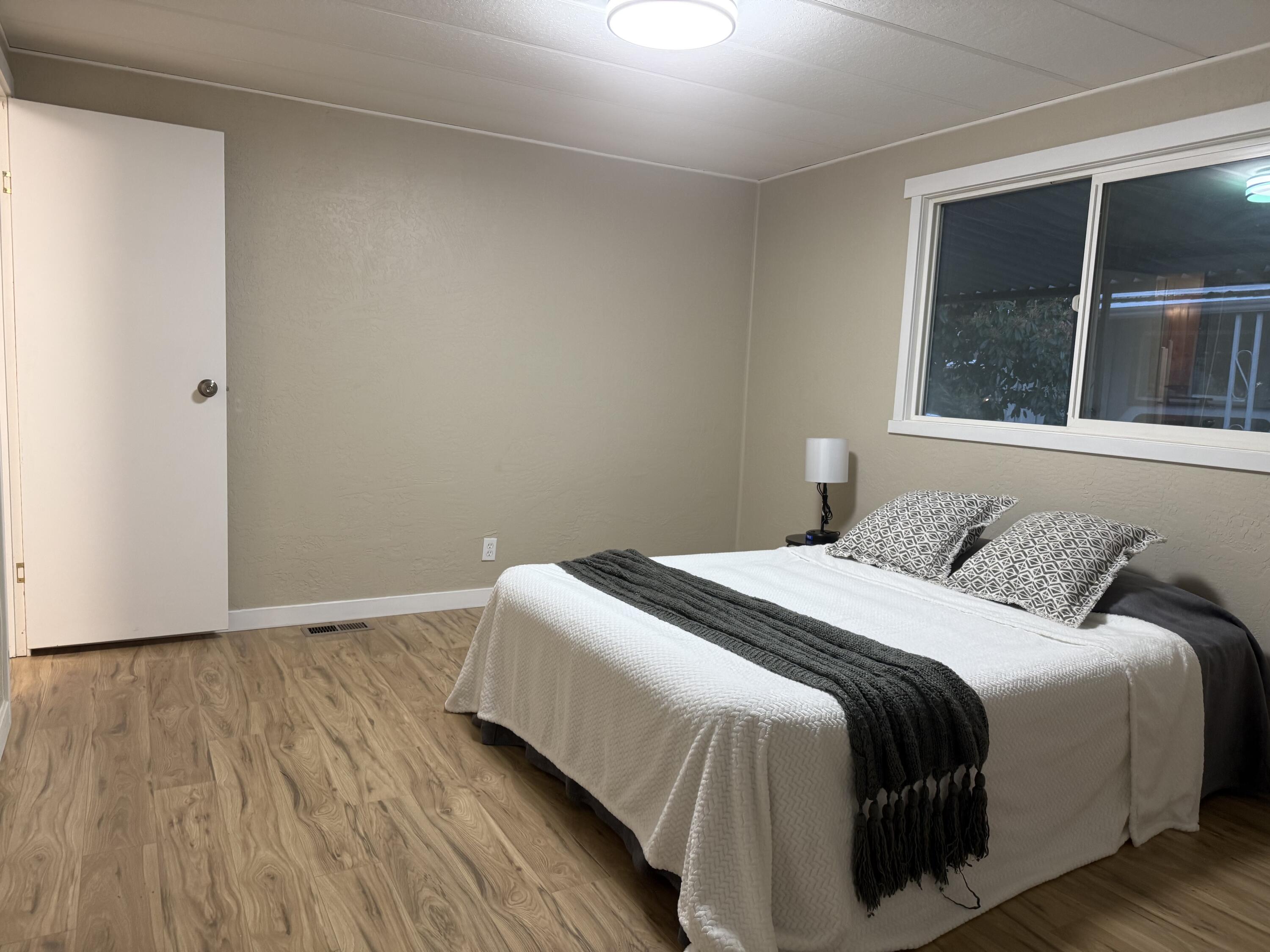 355 Colver Road, Unit 48 Talent, OR 97540 - Photo 23 of 30 a bedroom with a bed and window