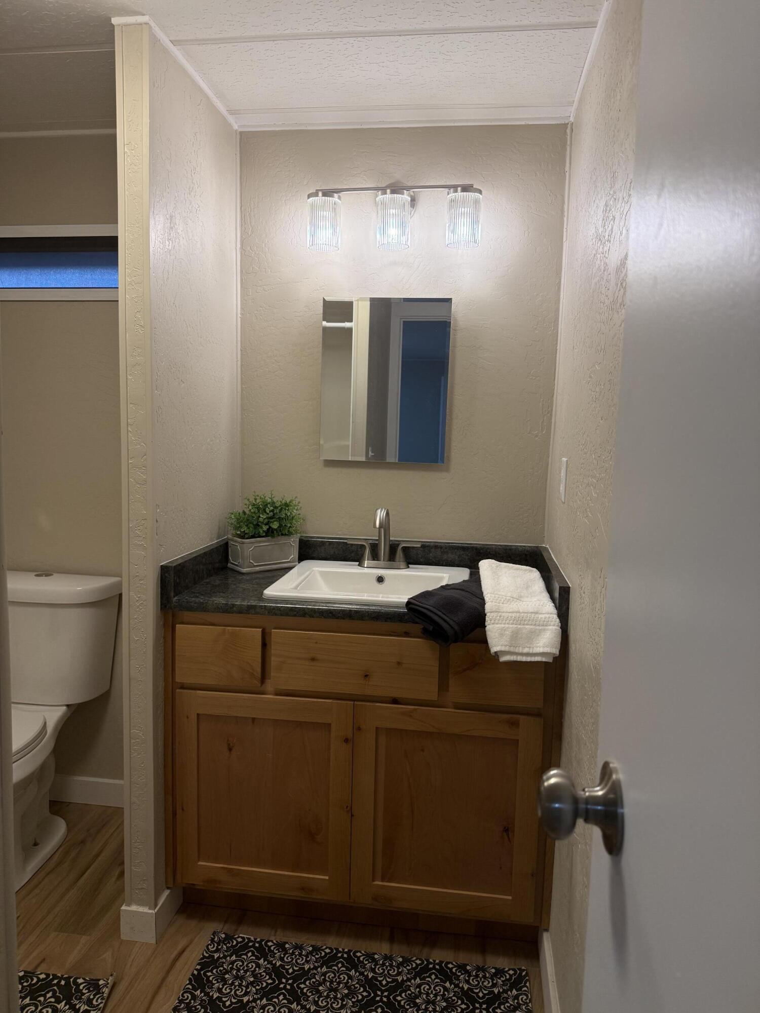 355 Colver Road, Unit 48 Talent, OR 97540 - Photo 26 of 30 a bathroom with a sink toilet and mirror