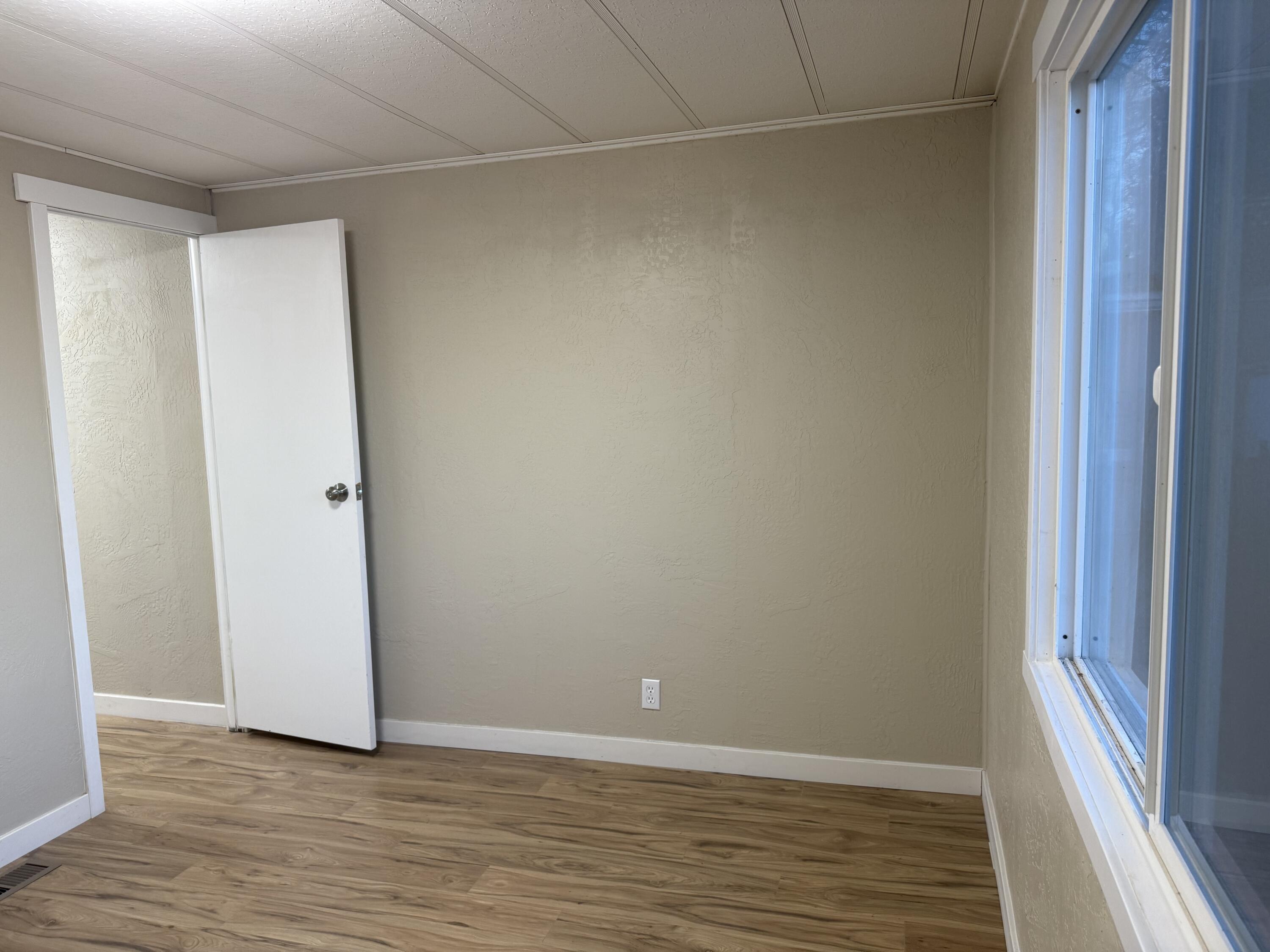 355 Colver Road, Unit 48 Talent, OR 97540 - Photo 28 of 30 a view of an empty room with wooden floor and a window