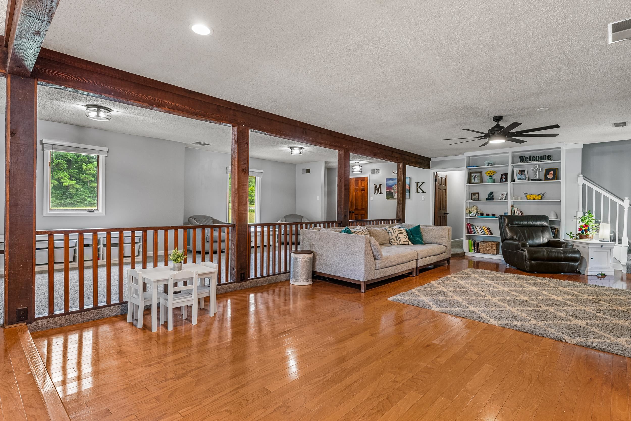 12389 Macon Road Collierville, TN 38017 - Photo 15 of 37 Living room featuring a textured ceiling, light wood-type flooring, ceiling fan, and a wealth of natural light