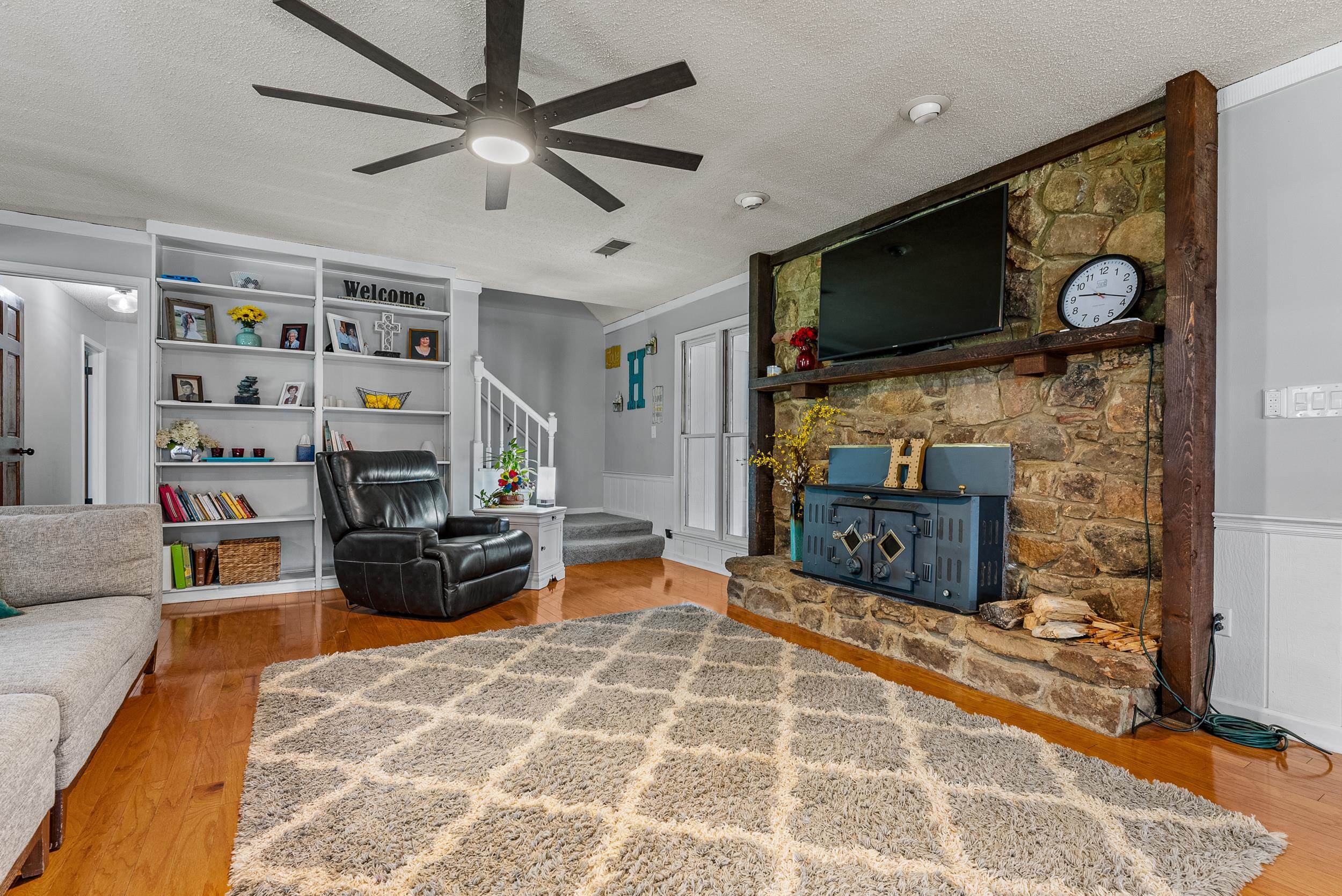 12389 Macon Road Collierville, TN 38017 - Photo 16 of 37 Living room with a textured ceiling, hardwood / wood-style floors, and ceiling fan