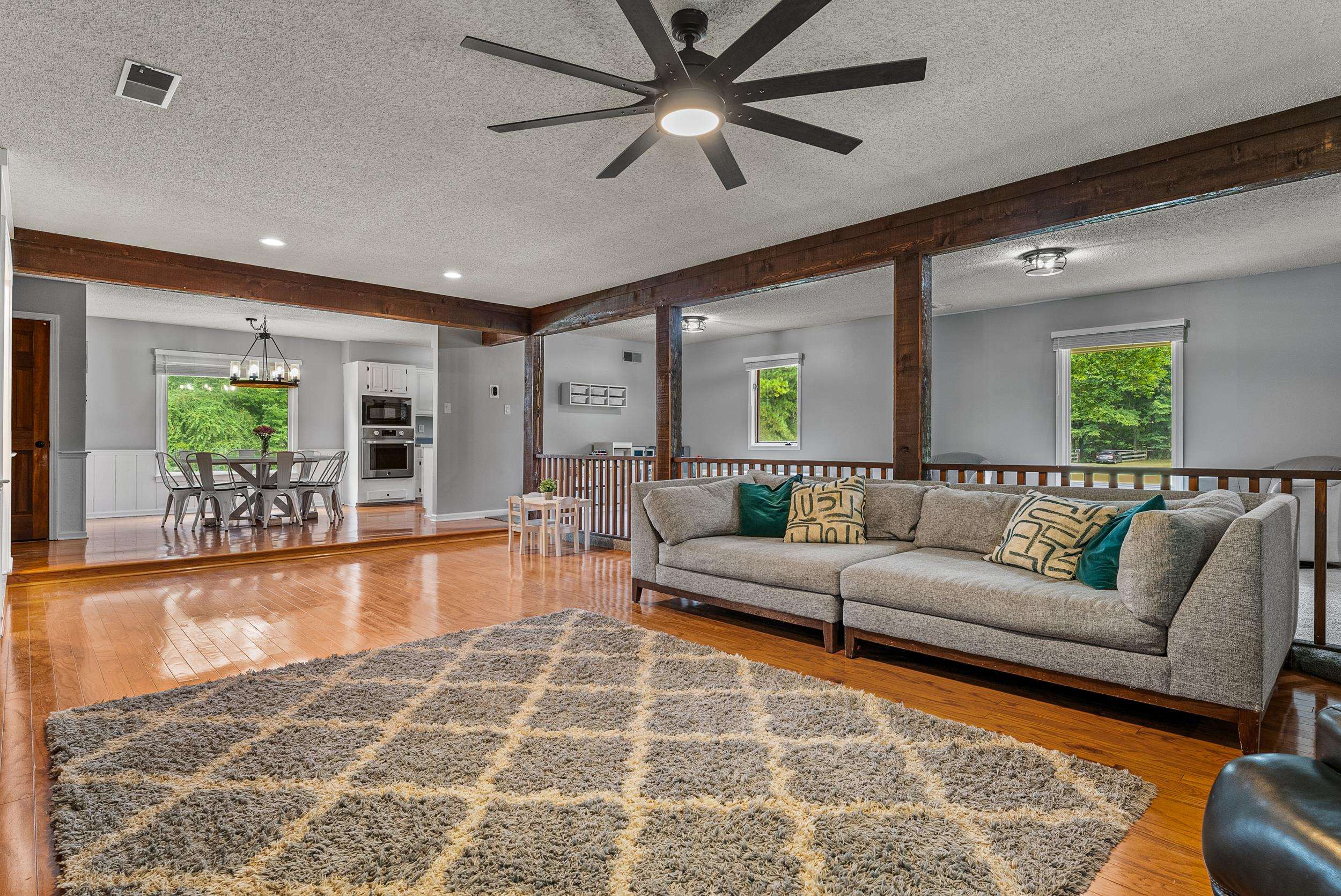 12389 Macon Road Collierville, TN 38017 - Photo 17 of 37 Living room featuring beamed ceiling, a textured ceiling, light wood-type flooring, and plenty of natural light
