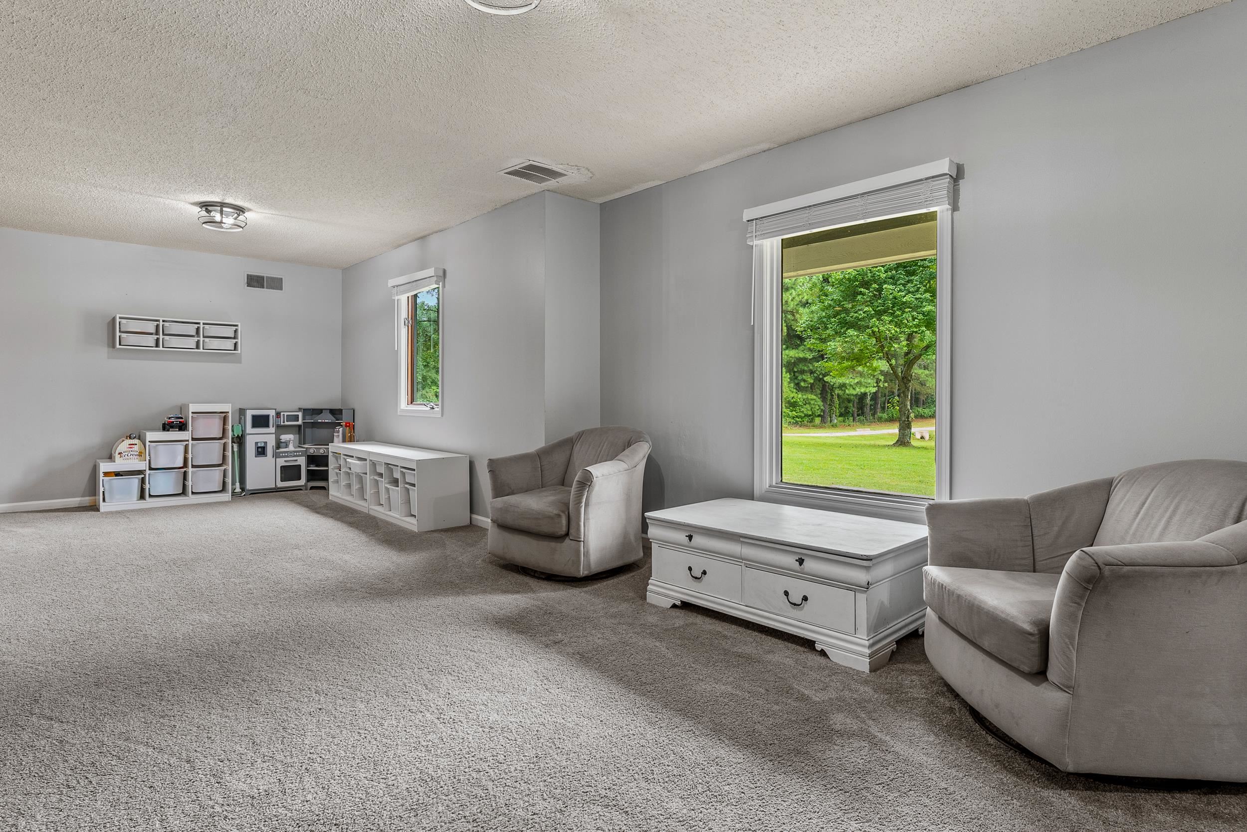 12389 Macon Road Collierville, TN 38017 - Photo 19 of 37 Sitting room featuring a textured ceiling and carpet floors