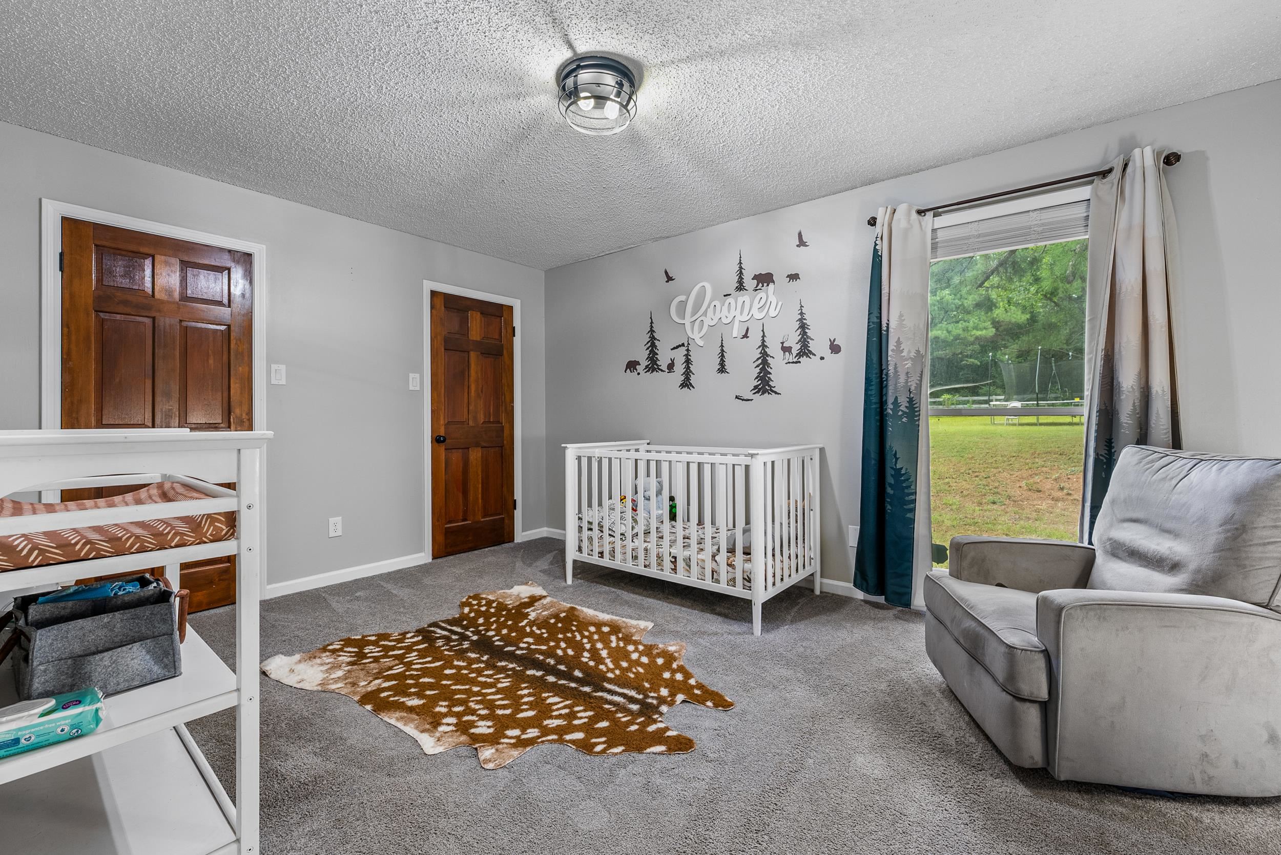 12389 Macon Road Collierville, TN 38017 - Photo 28 of 37 Bedroom with a textured ceiling, a nursery area, and carpet