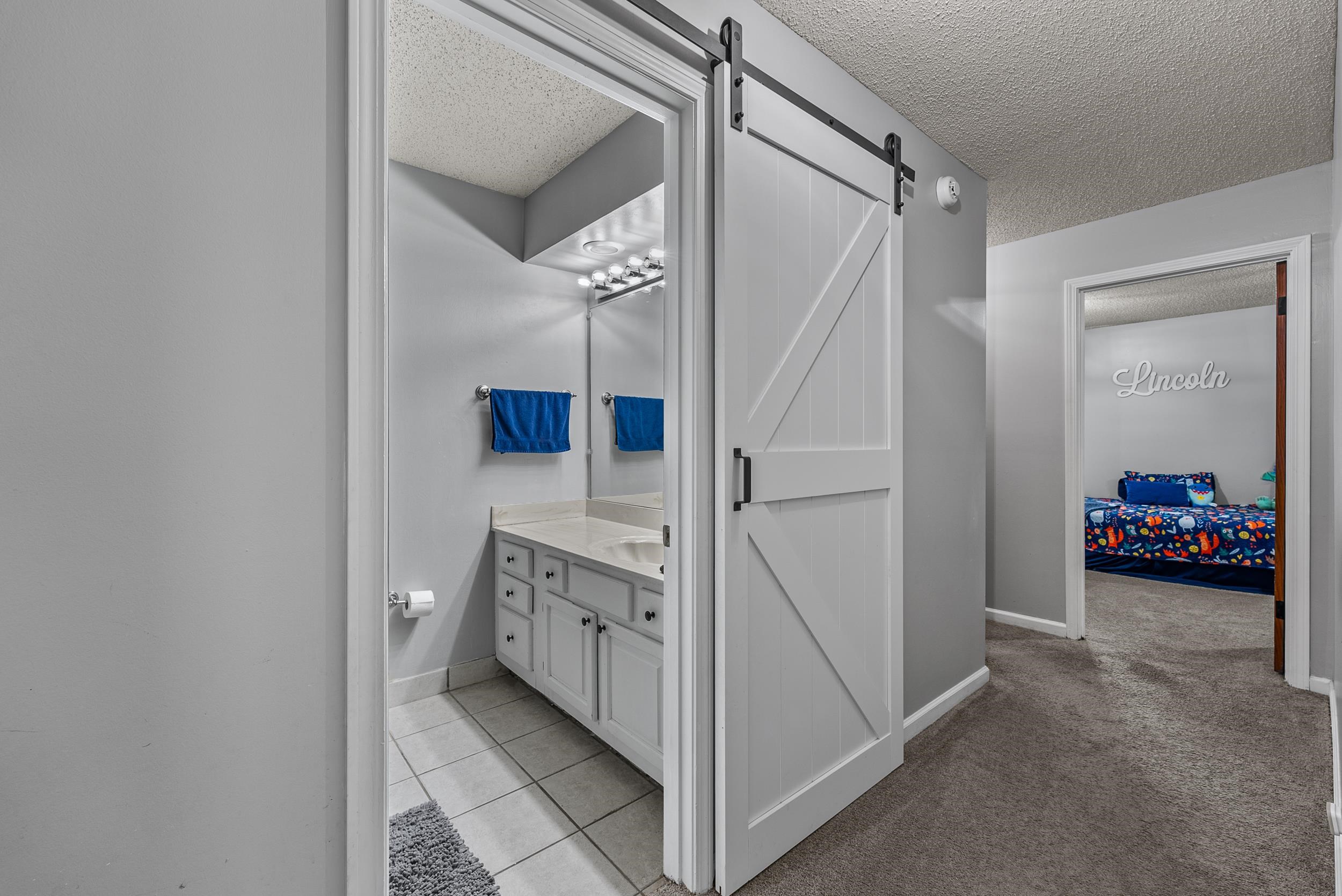 12389 Macon Road Collierville, TN 38017 - Photo 29 of 37 Bathroom with tile patterned floors, vanity, and a textured ceiling