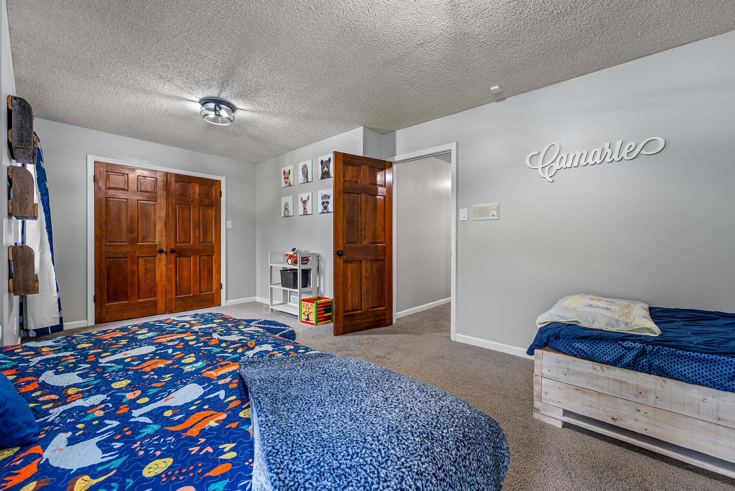 12389 Macon Road Collierville, TN 38017 - Photo 32 of 37 Carpeted bedroom with a textured ceiling and a closet