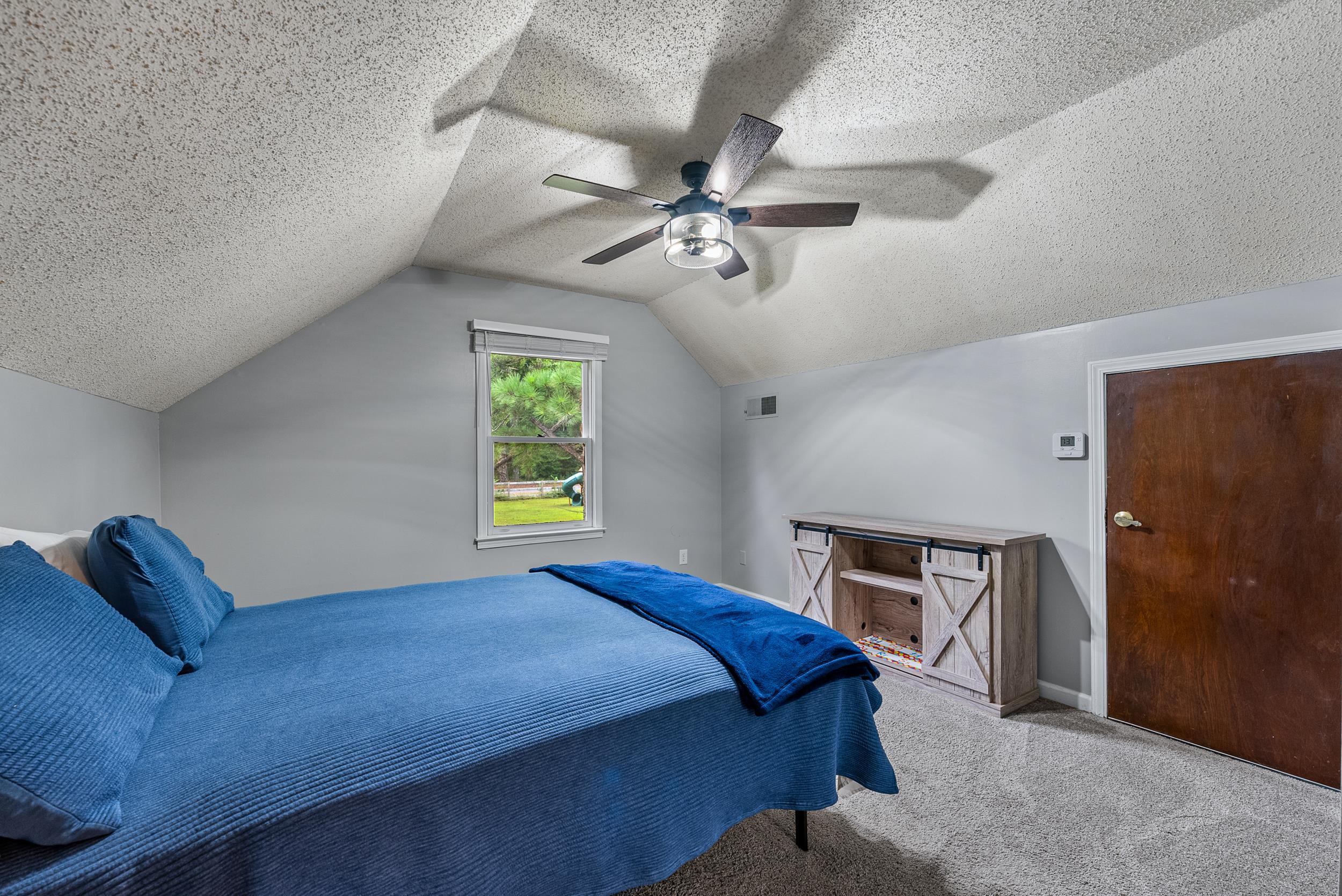 12389 Macon Road Collierville, TN 38017 - Photo 35 of 37 Carpeted bedroom with ceiling fan, a textured ceiling, and lofted ceiling