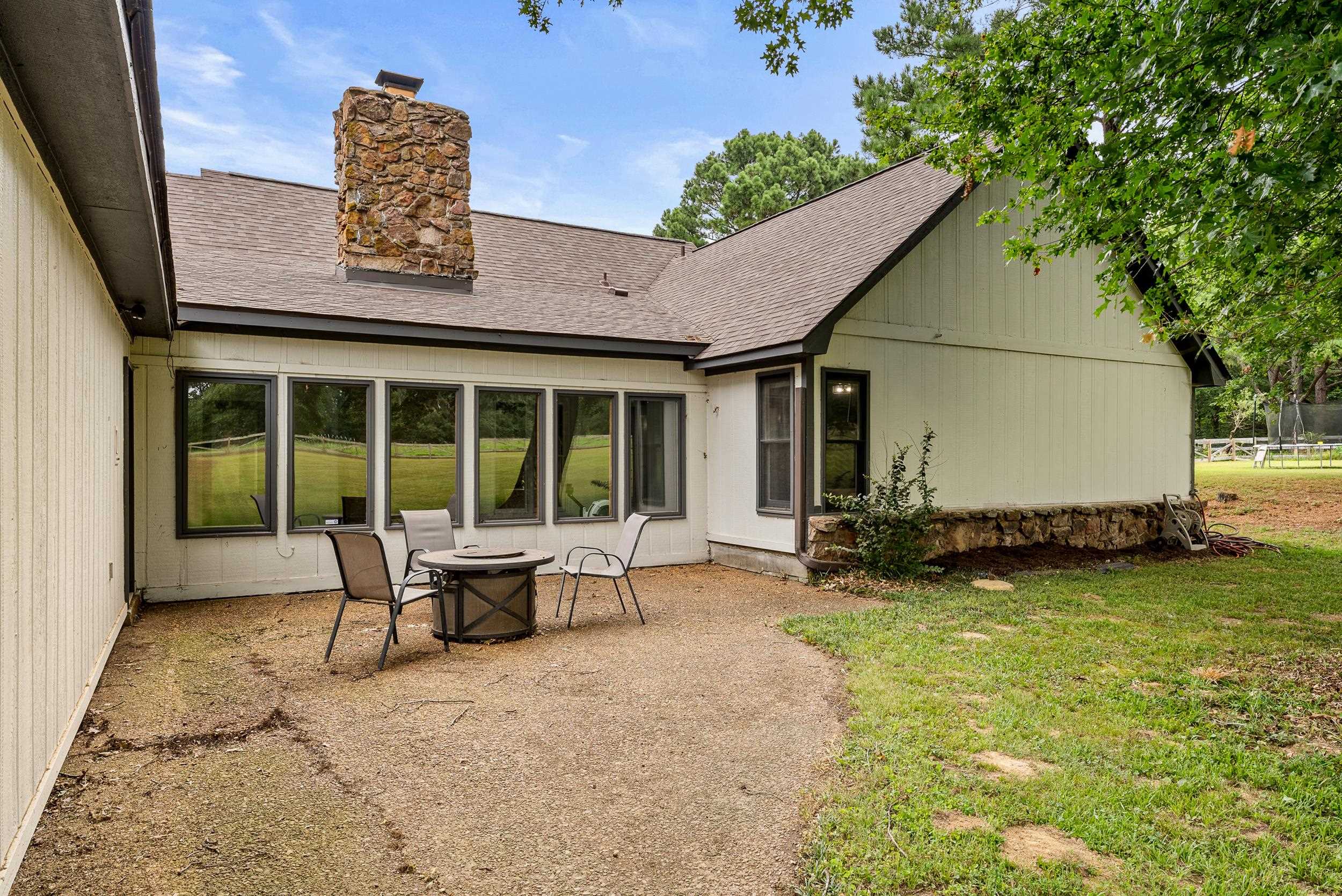 Back of property with a patio and a lawn