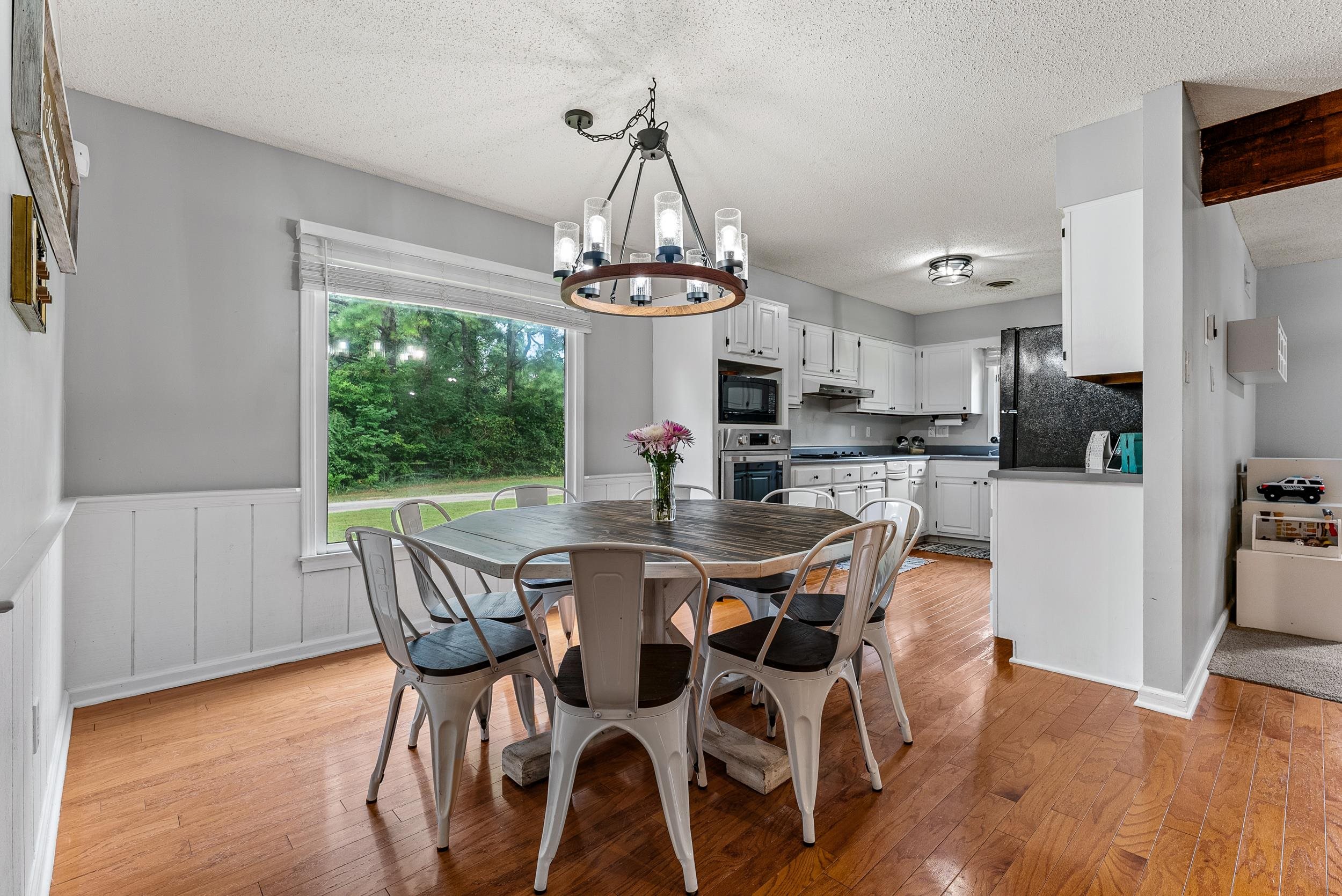 12389 Macon Road Collierville, TN 38017 - Photo 9 of 37 Dining space featuring light hardwood / wood-style flooring, a chandelier, and a textured ceiling