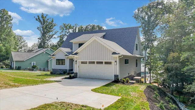 a bathroom with double vanity sinks a mirror and lamp
