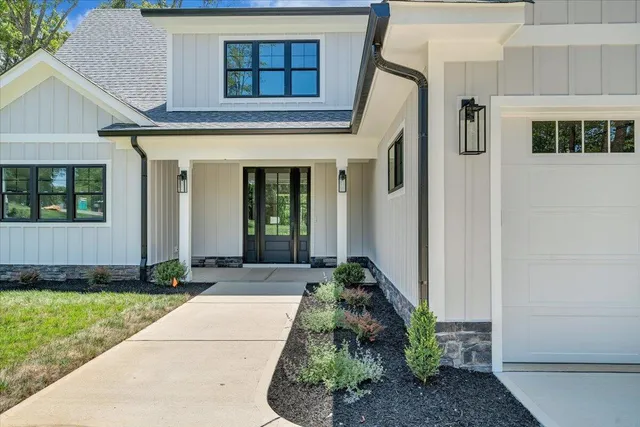 a spacious bathroom with double vanity a glass door shower and a mirror