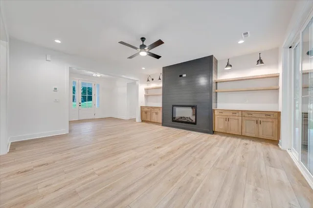 a view of kitchen with white cabinets and sink