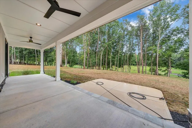 a spacious bedroom with a bed and a window
