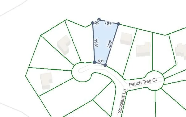 a view of a street with a yard and trees