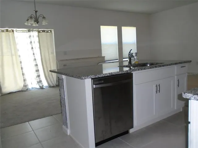 a kitchen with a sink and a refrigerator