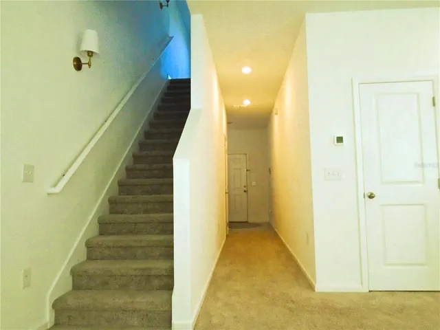a view of a hallway with staircase