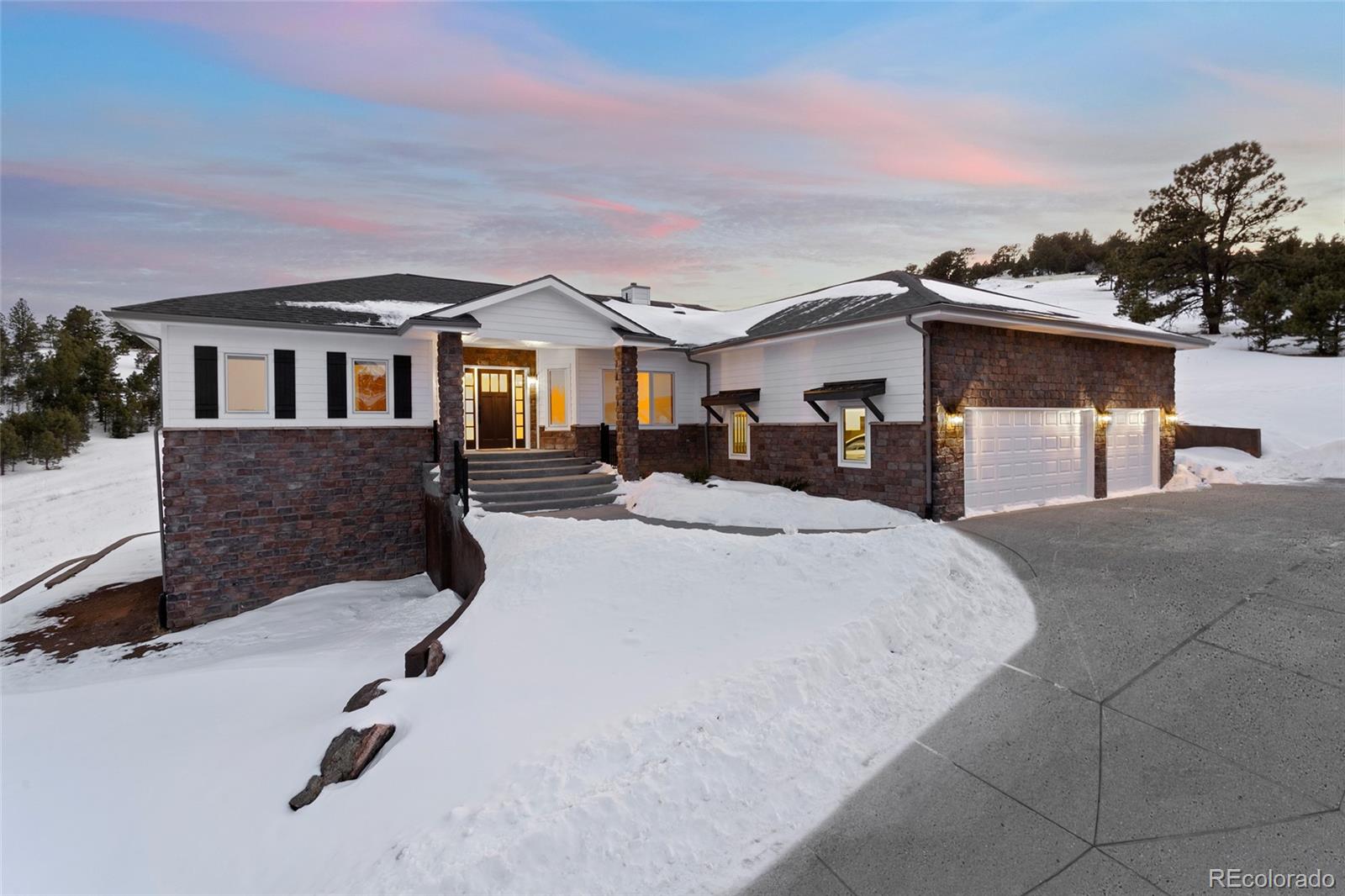 a view of a house with a snow in the background