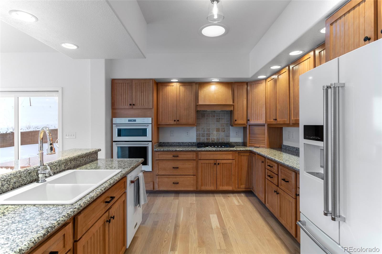 1305 South Grapevine Road Golden, CO 80401 - Photo 19 of 39 a large kitchen with granite countertop a sink and cabinets