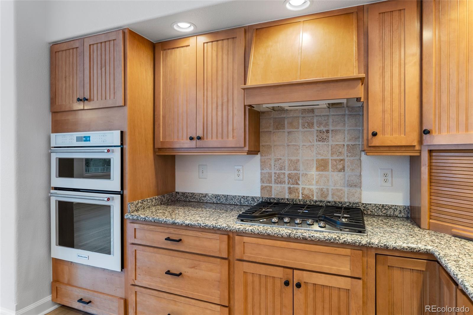 1305 South Grapevine Road Golden, CO 80401 - Photo 20 of 39 a kitchen with granite countertop cabinets stainless steel appliances and a window