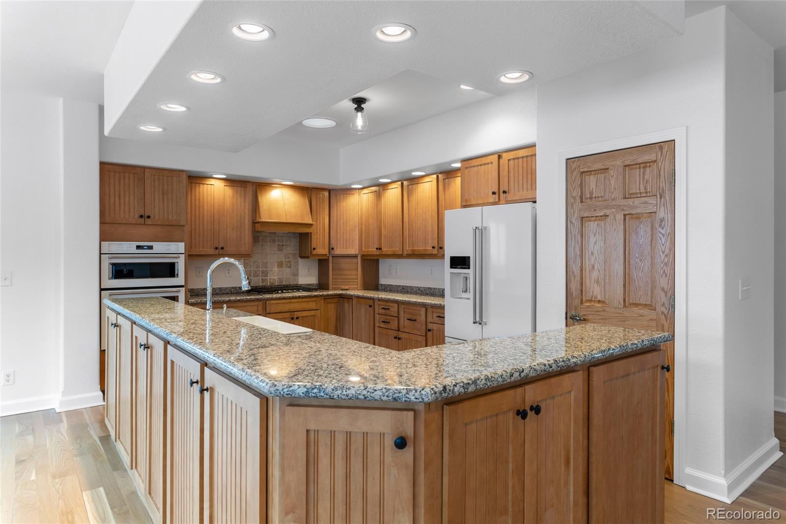 1305 South Grapevine Road Golden, CO 80401 - Photo 21 of 39 a kitchen with stainless steel appliances granite countertop a sink and a refrigerator