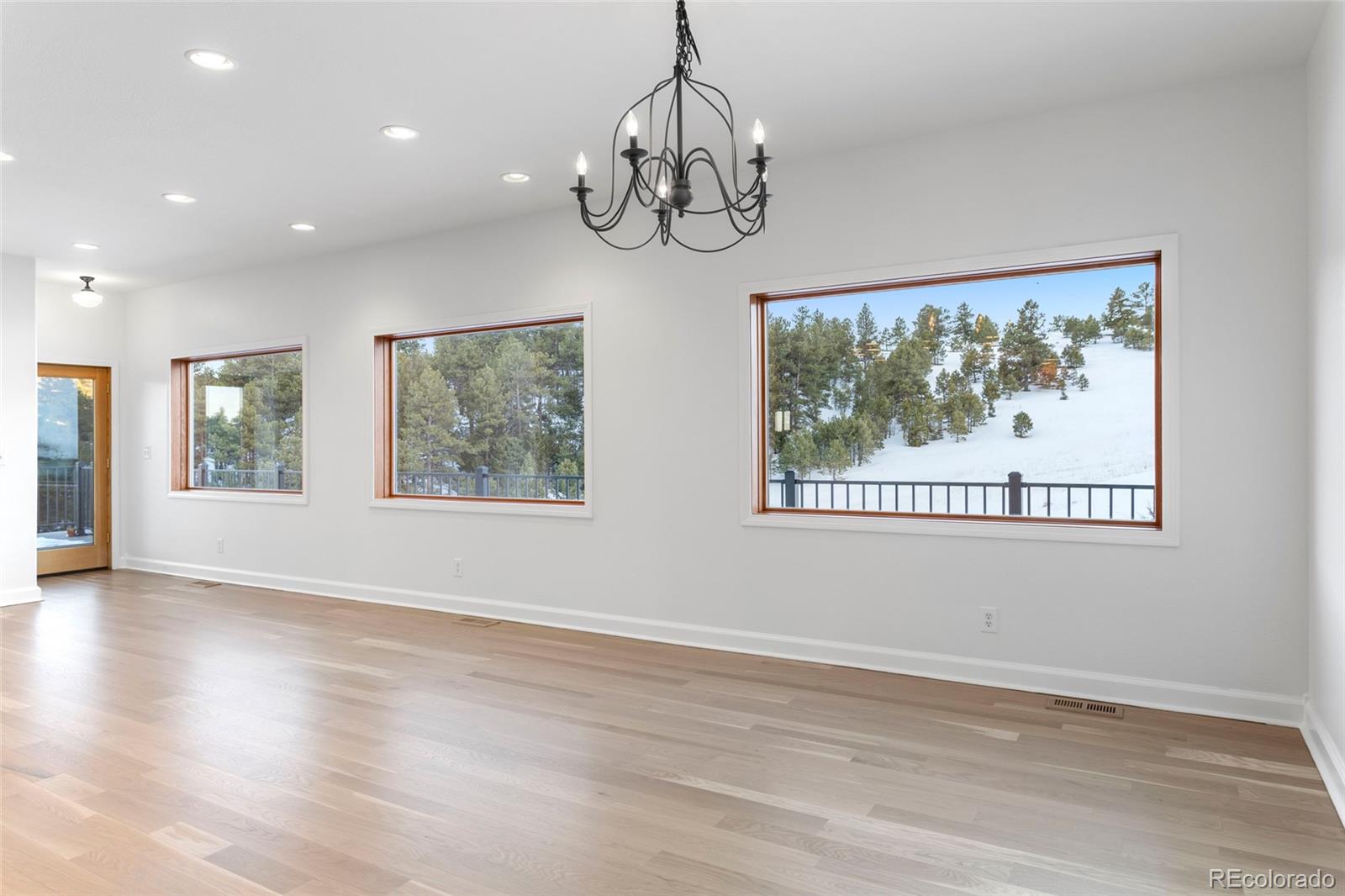 1305 South Grapevine Road Golden, CO 80401 - Photo 22 of 39 a view of empty room with wooden floor and fan