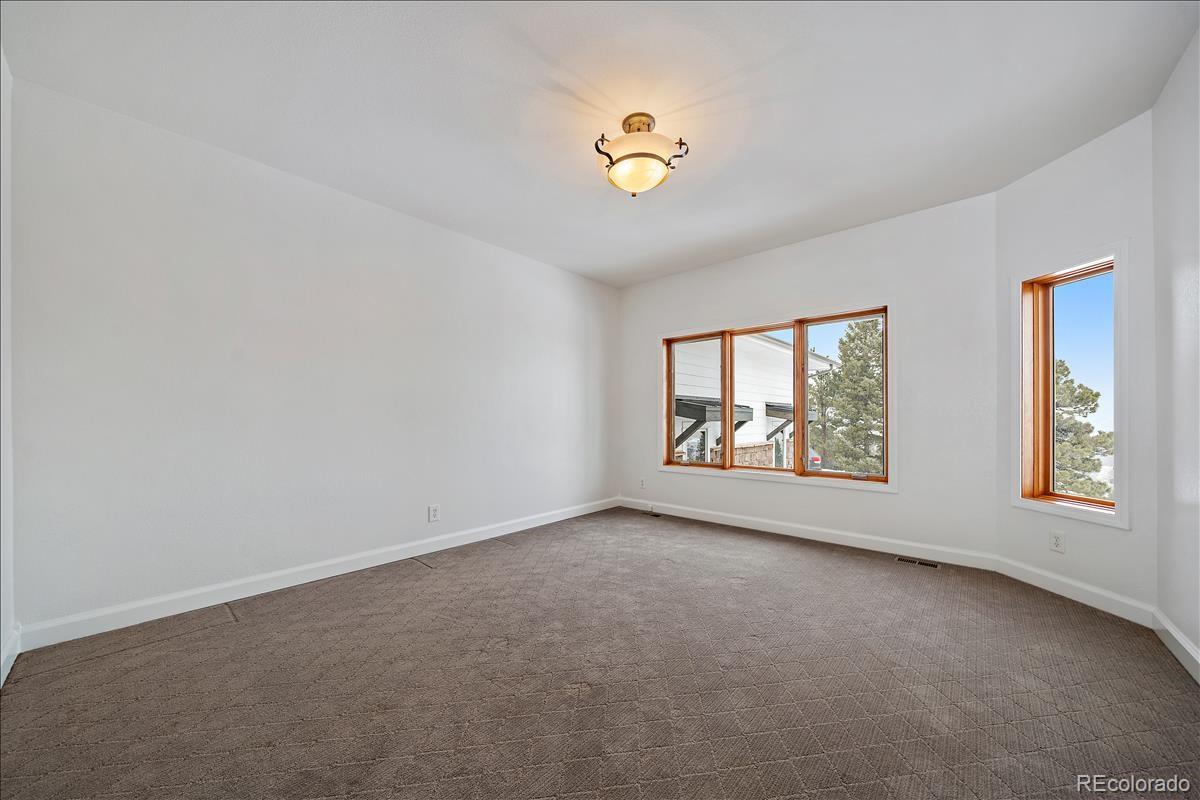 1305 South Grapevine Road Golden, CO 80401 - Photo 25 of 39 a view of an empty room with a window