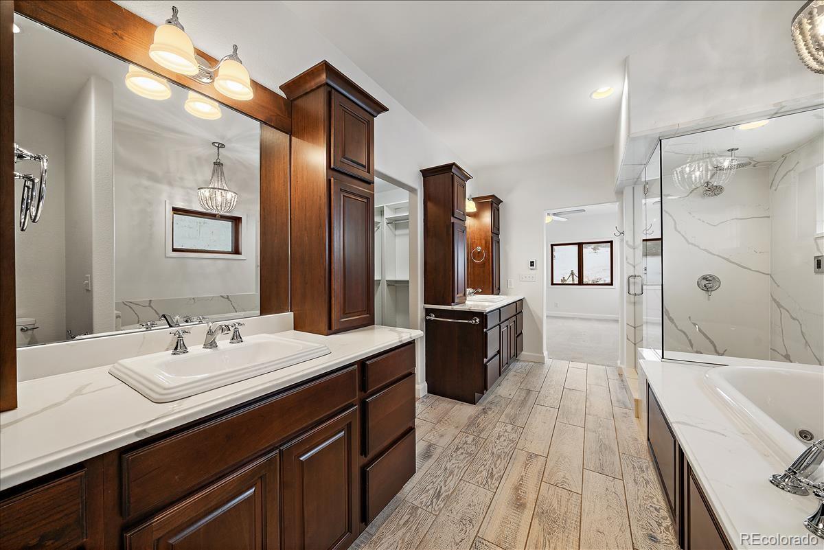 1305 South Grapevine Road Golden, CO 80401 - Photo 27 of 39 a spacious bathroom with a tub sink and mirror