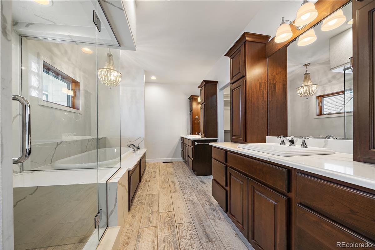 1305 South Grapevine Road Golden, CO 80401 - Photo 28 of 39 a spacious bathroom with a bathtub sink and mirror