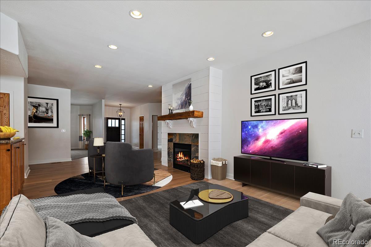 1305 South Grapevine Road Golden, CO 80401 - Photo 10 of 39 a living room with furniture a fireplace and a flat screen tv