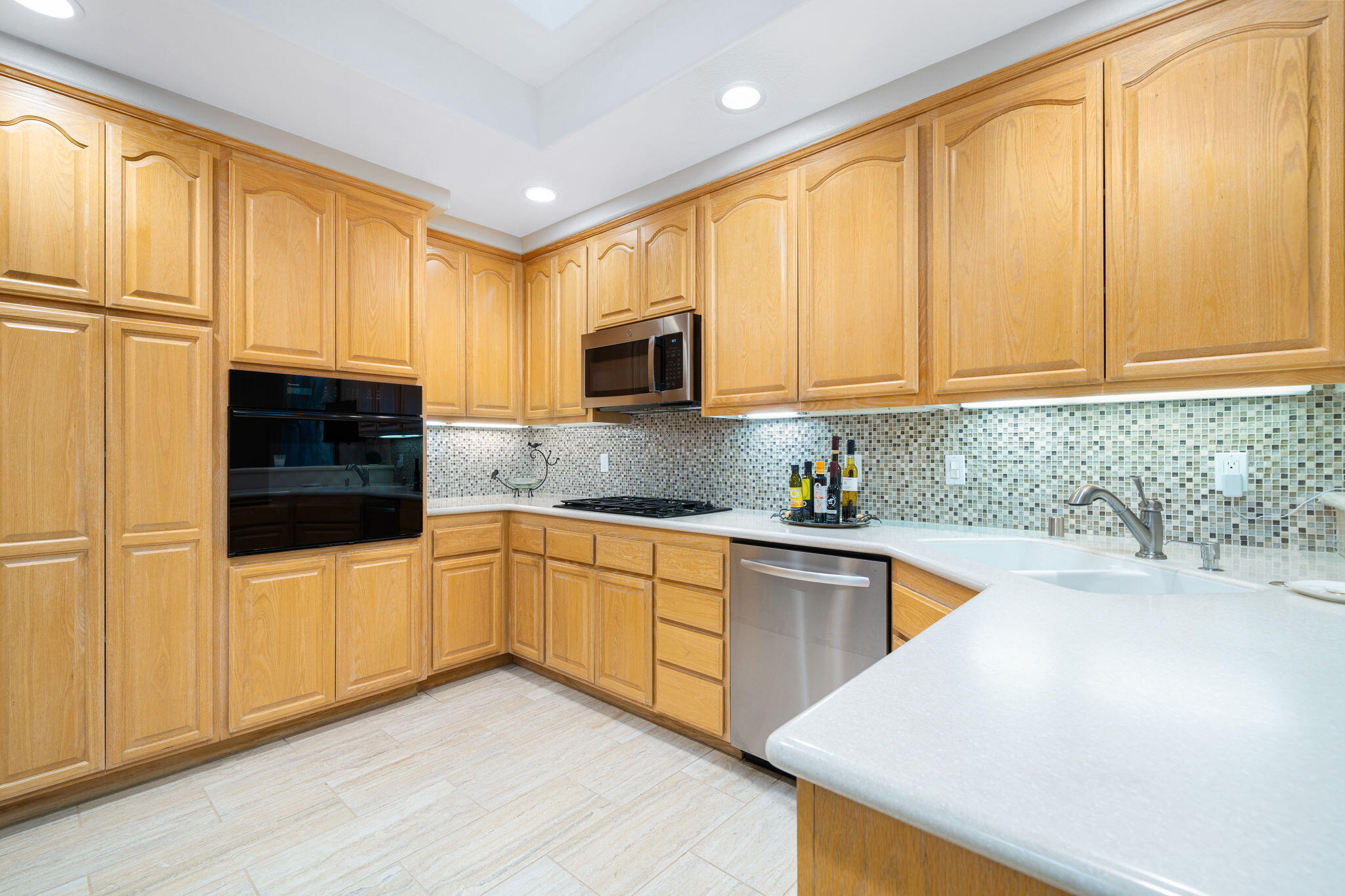 702 Inverness Drive Rancho Mirage, CA 92270 - Photo 21 of 49 a kitchen with stainless steel appliances granite countertop a sink a stove and cabinets