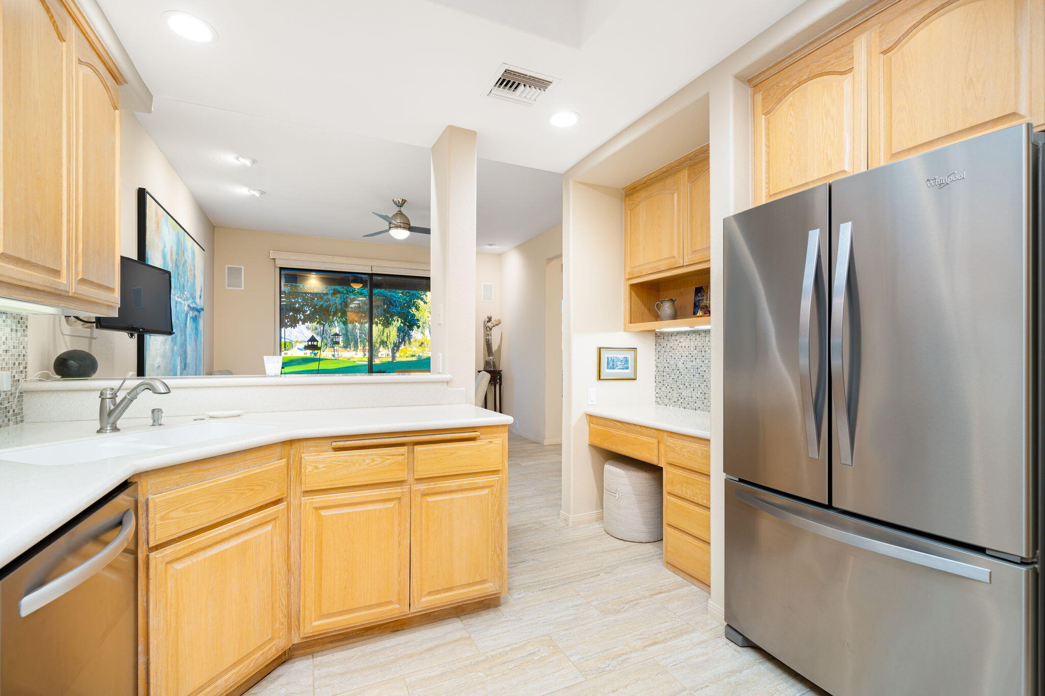 702 Inverness Drive Rancho Mirage, CA 92270 - Photo 23 of 49 a kitchen with stainless steel appliances a refrigerator sink and cabinets