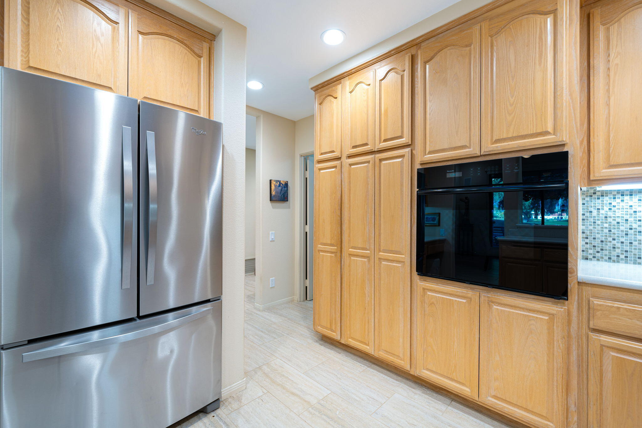 702 Inverness Drive Rancho Mirage, CA 92270 - Photo 24 of 49 a kitchen with stainless steel appliances a refrigerator and cabinets