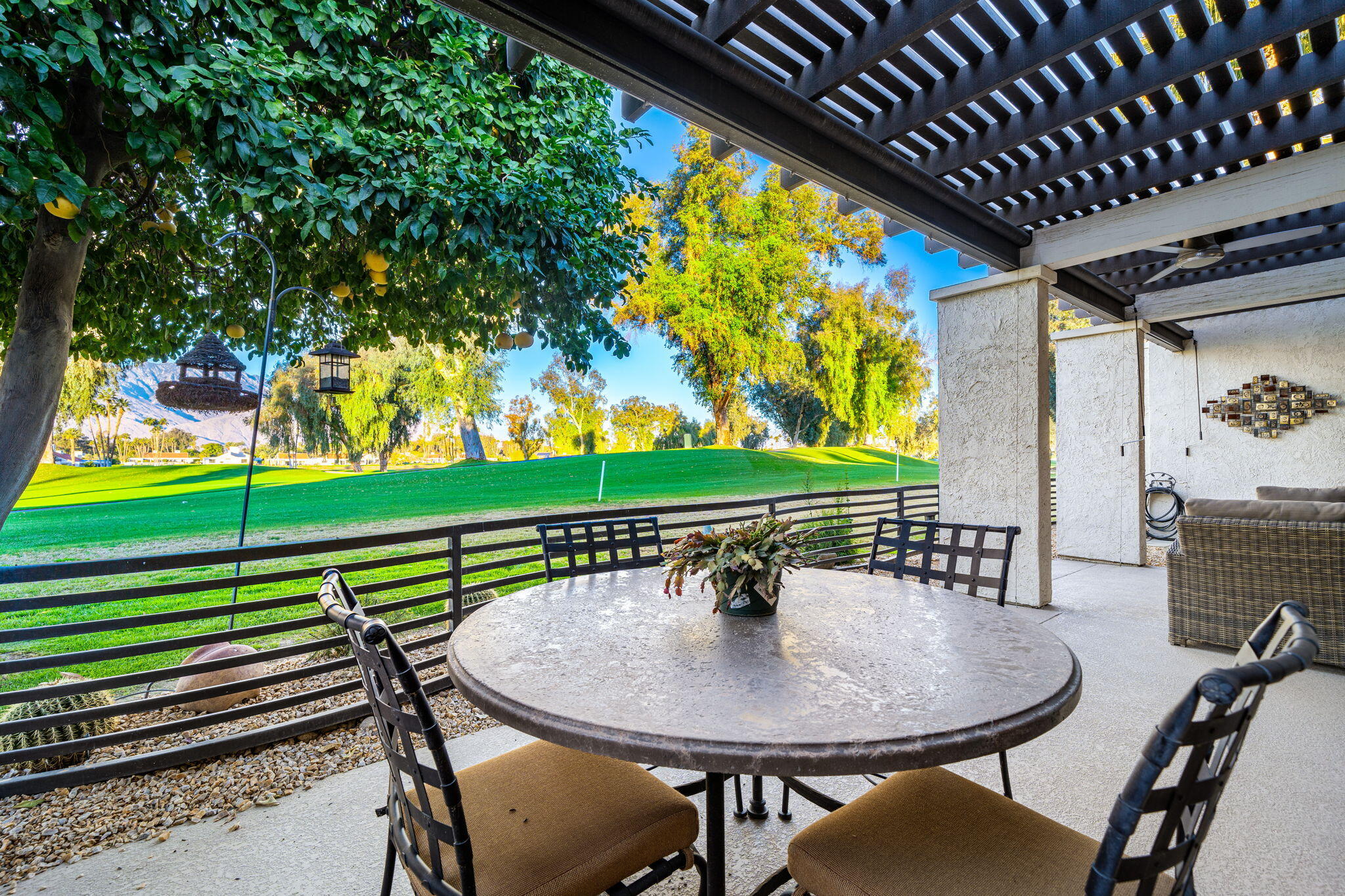702 Inverness Drive Rancho Mirage, CA 92270 - Photo 28 of 49 a view of a chairs and table in patio