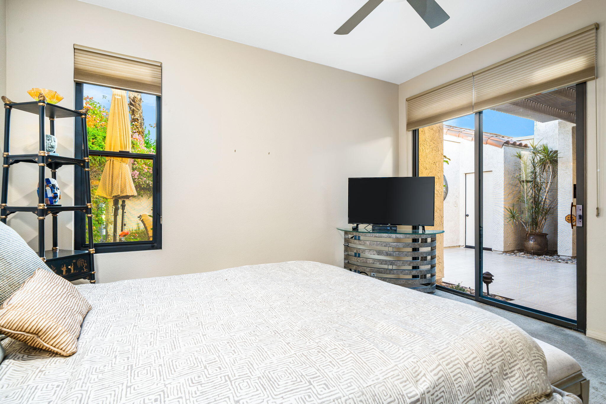 702 Inverness Drive Rancho Mirage, CA 92270 - Photo 37 of 49 a bedroom with a bed and a flat screen tv