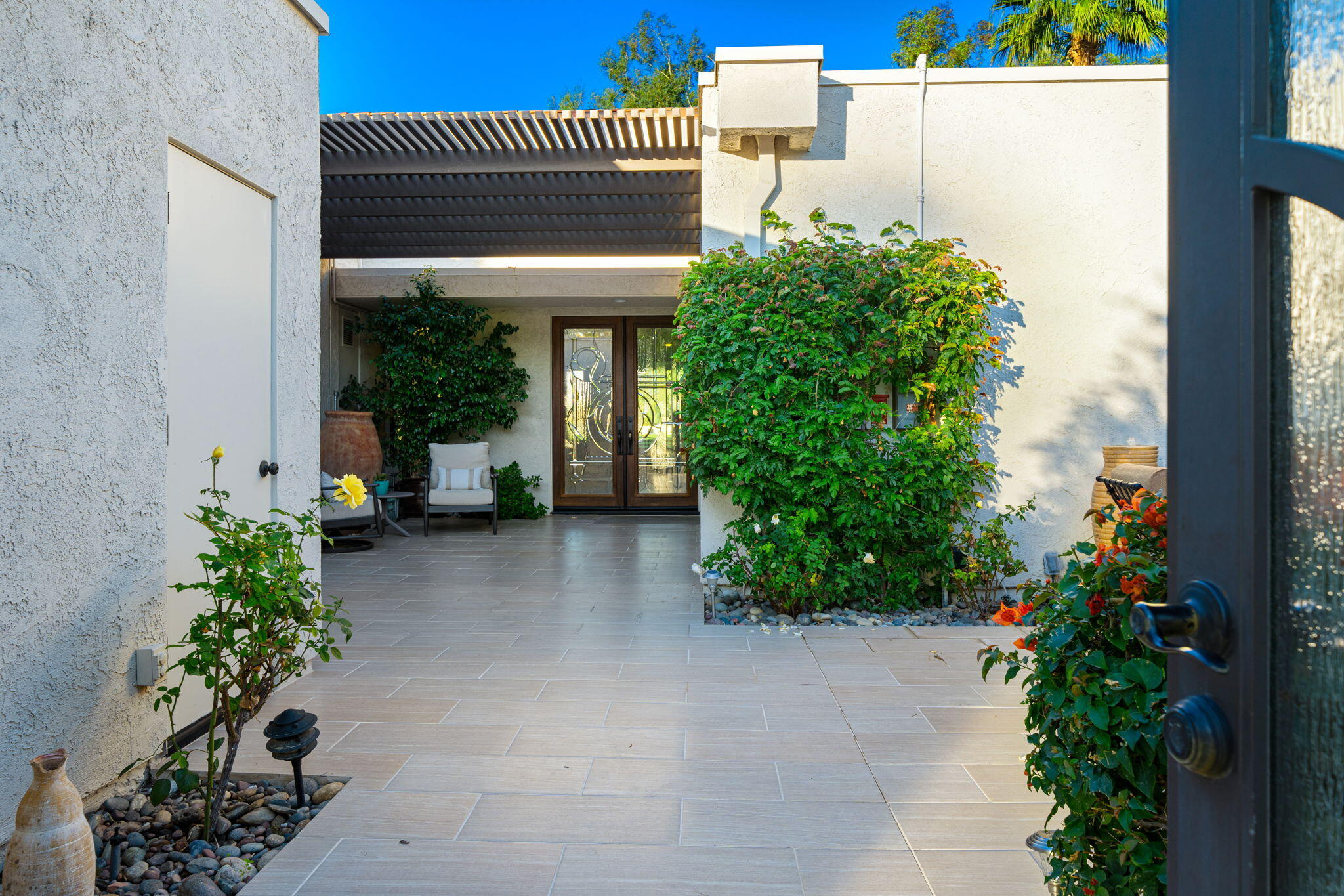 702 Inverness Drive Rancho Mirage, CA 92270 - Photo 7 of 49 a view of a house with potted plants