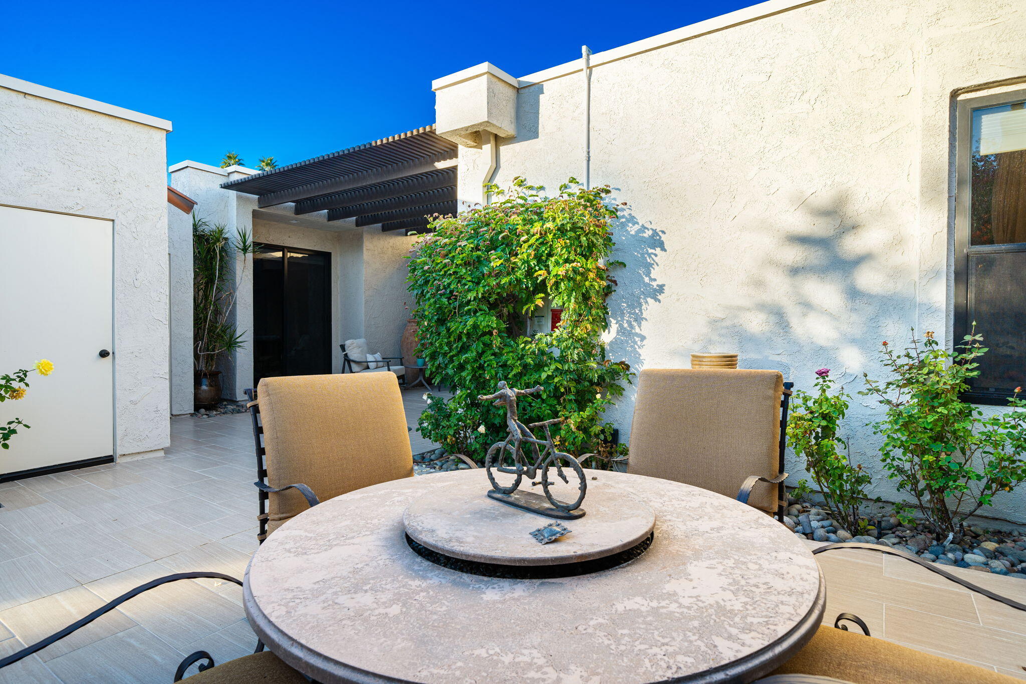 702 Inverness Drive Rancho Mirage, CA 92270 - Photo 9 of 49 a view of a porch with furniture and a potted plant
