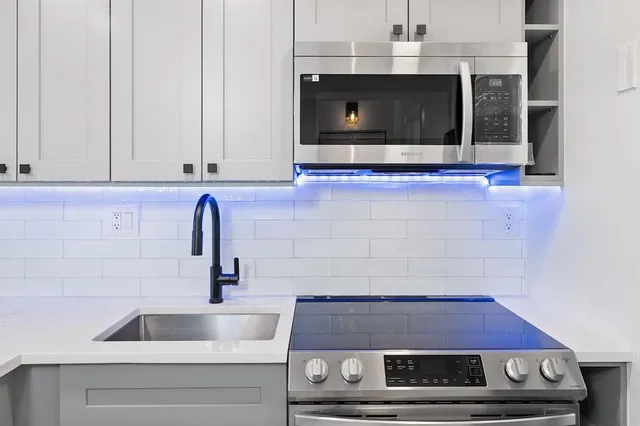 a bathroom with a sink and a microwave
