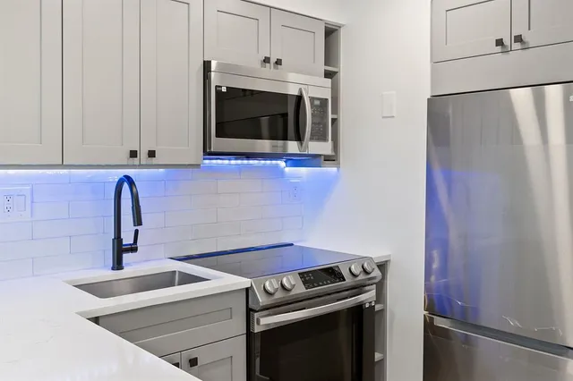 a kitchen with a stove and a microwave